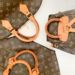 High-end designer leather handbags with monogram pattern lay elegantly displayed.