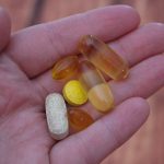person holding medication pills
