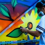 man paint flower on wall