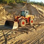 a bulldozer is parked on a dirt road