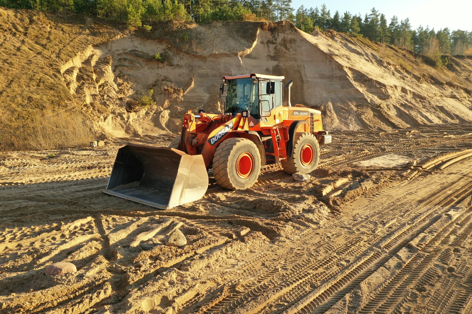 a bulldozer is parked on a dirt road